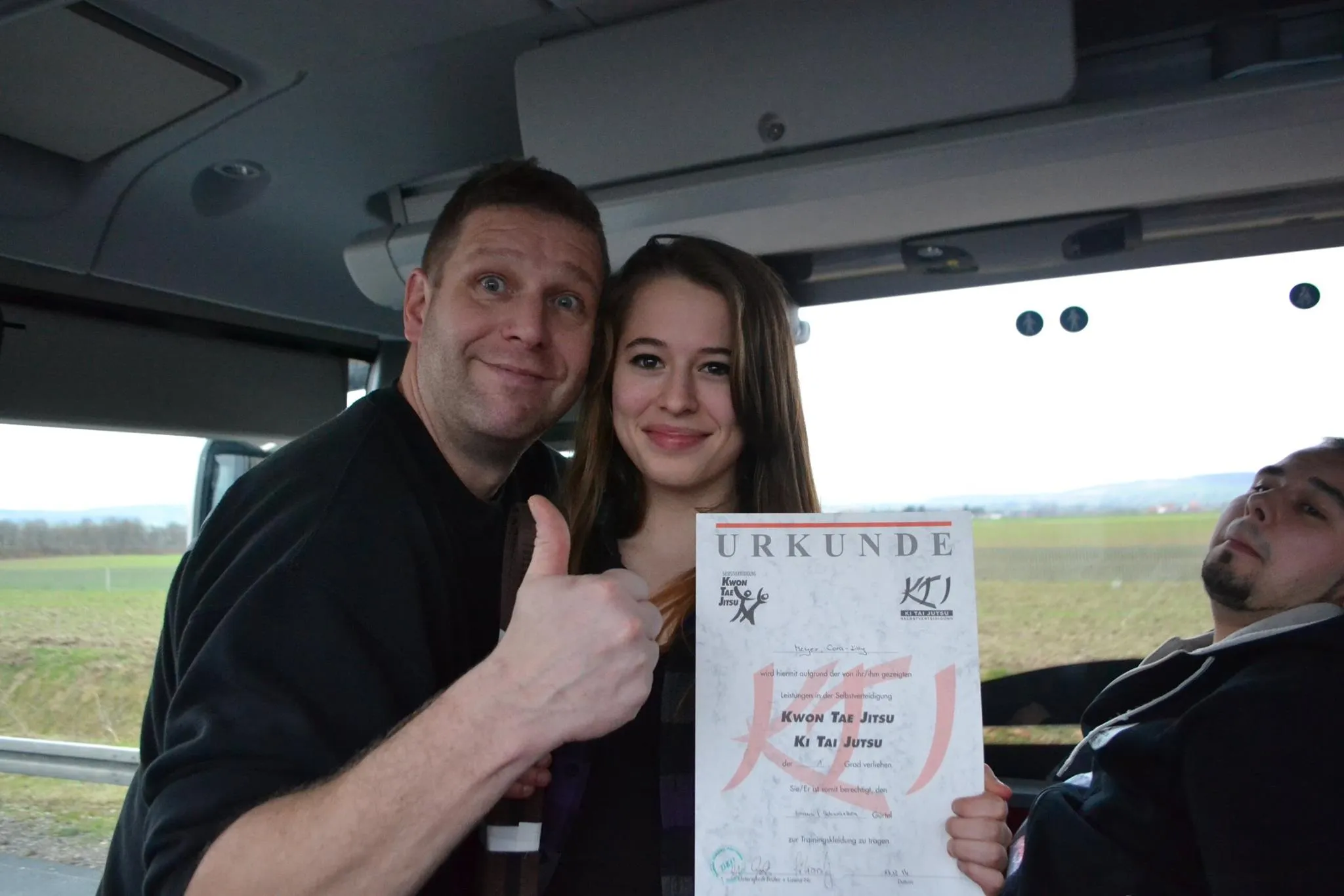 Cora bekommt ihre Urkunde im Bus überreicht